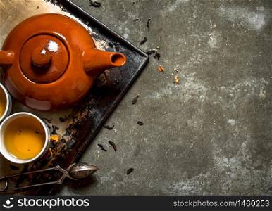 Fragrant tea brewed in a teapot. On the stone table.. Fragrant tea brewed in a teapot.