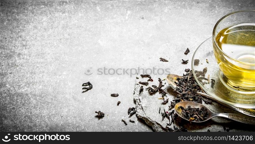 Fragrant tea in the Cup. On a stone background. Fragrant tea in the Cup.