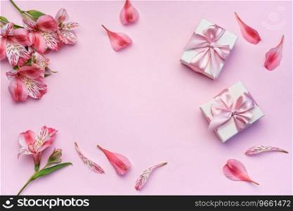 Frame for the text of congratulations with  flowers of Alstroemeria and gift boxes on a pink background. Greeting card with natural colors. Background for text with alstromeria. Flat lay, top view.