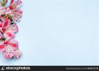 Frame for the text of congratulations with  flowers of Alstroemeria on a blue background. Greeting card with natural colors. Background for text with alstromeria. Flat lay, top view.