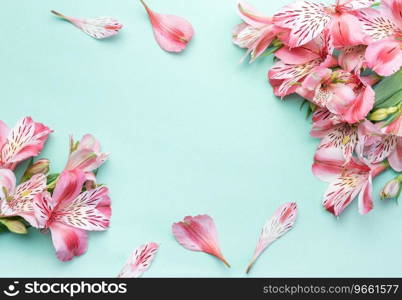 Frame for the text of congratulations with  flowers of Alstroemeria on a light green background. Greeting card with natural colors. Background for text with alstromeria. Flat lay, top view.