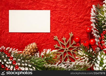 Frame from Christmas tree decorations on red paper with blank