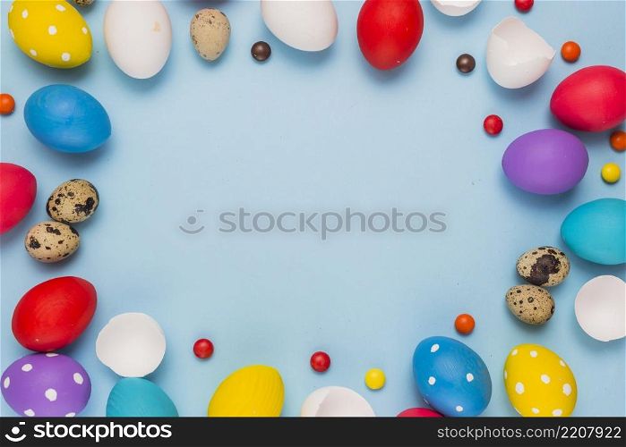 frame from easter eggs candies blue table