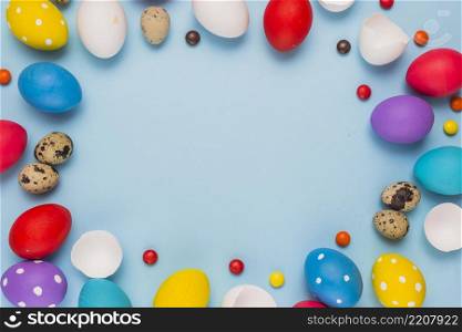 frame from easter eggs candies blue table