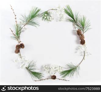 Frame from pine tree branches with cones on white background. Christmas holidays flat lay