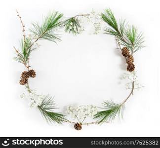 Frame from pine tree branches with cones on white background. Christmas holidays flat lay. Christmas decoration
