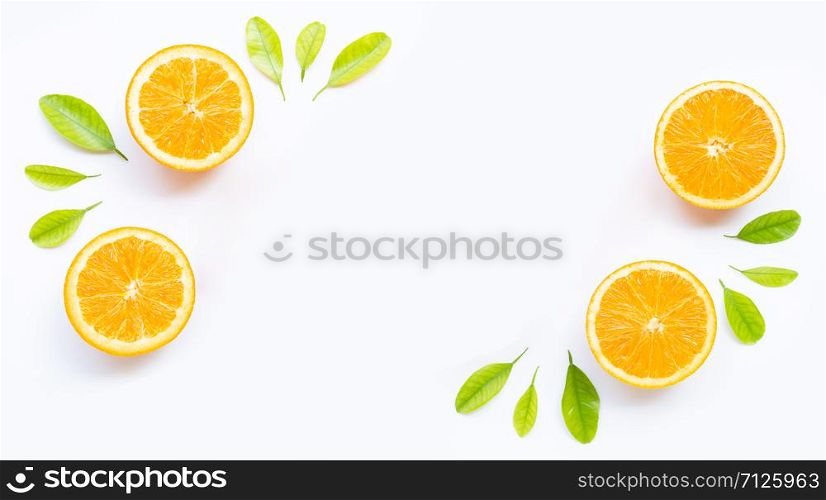 Frame made of fresh orange fruit with green leaves on white background