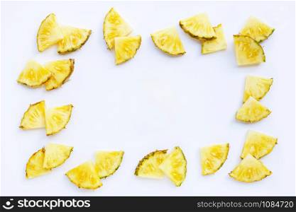 Frame made of fresh pineapple on white background. Top view