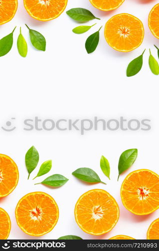 Frame made of Orange with green leaves isolated on white background. Copy space