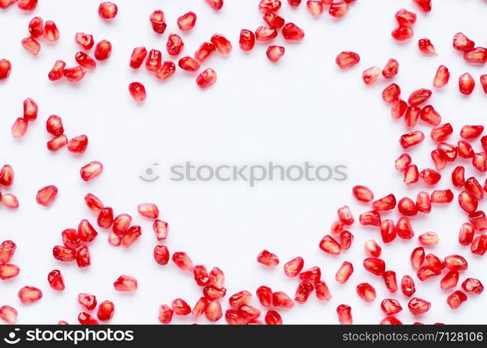 Frame made of pomegranate seeds isolated on white background. Copy space