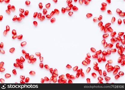 Frame made of pomegranate seeds isolated on white background. Copy space