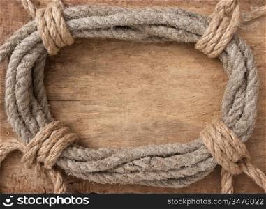 frame made of twisted rope on a wooden background