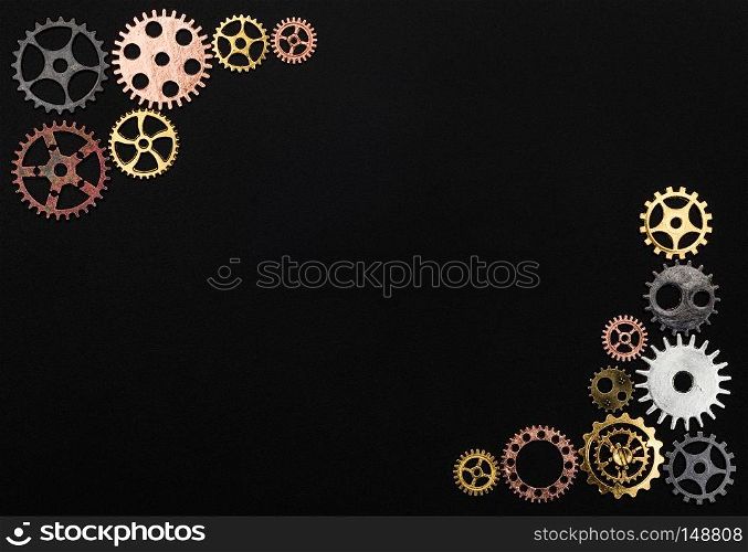 Frame made out of cogwheels on a black background. Copyspace.. Frame made out of cogwheels