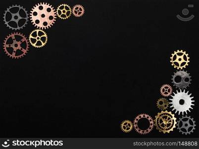 Frame made out of cogwheels on a black background. Copyspace.. Frame made out of cogwheels