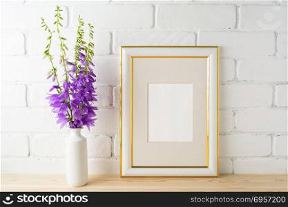 Frame mockup with bluebells bouquet. Frame mockup with bluebells bouquet. Portrait or poster white frame mockup. Empty white frame mockup for presentation artwork.