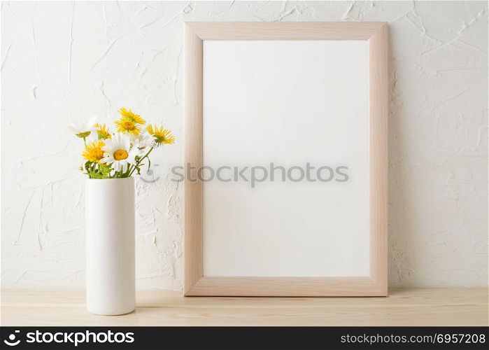 Frame mockup with white and yellow chamomiles in vase. Poster white frame mockup. Empty white frame mockup for presentation design.. Frame mockup with white and yellow chamomiles in vase