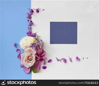 frame of flowers on a colored background with a place under the text, flat lay. Frame of spring flowers
