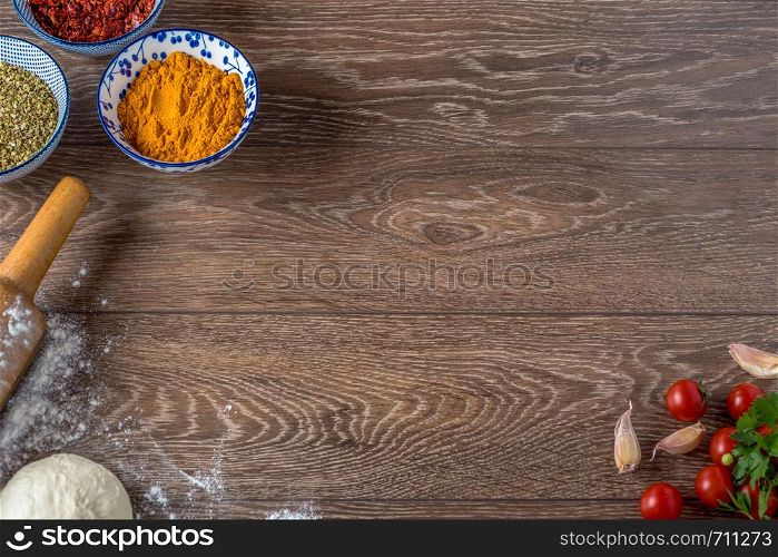 Frame of food and spices on wooden background