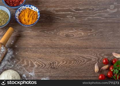 Frame of food and spices on wooden background