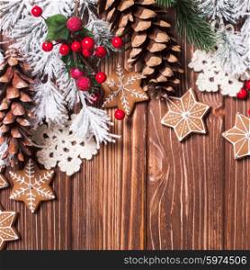 Frame of gingerbreads and winter decor on a wooden background.. Christmas backgrounds