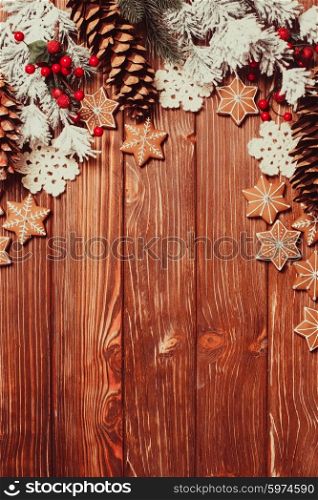 Frame of gingerbreads and winter decor on a wooden background.. The Christmas backgrounds