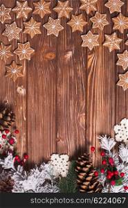 Frame of gingerbreads on a wooden background.. The Christmas backgrounds