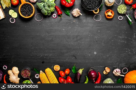 Frame of organic food. Fresh raw vegetables with black beans. On a black chalkboard.. Frame of organic food. Fresh raw vegetables with black beans.