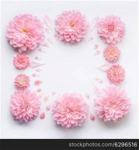 Frame of pink pale flowers with petals on white desktop background, flat lay, top view. Creative floral layout or mock up for greeting card for Mothers day, wedding , happy event or birthday