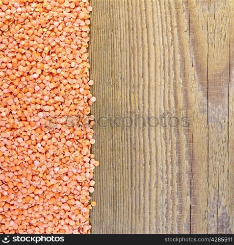 Frame of red lentils on the left side of wooden boards