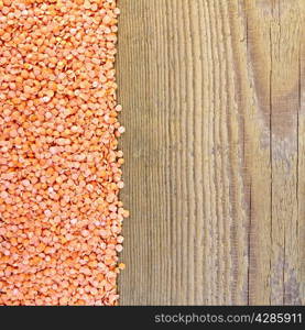 Frame of red lentils on the left side of wooden boards