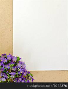 Frame purple wildflowers, white and rough brown paper