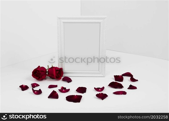 frame with red roses white table