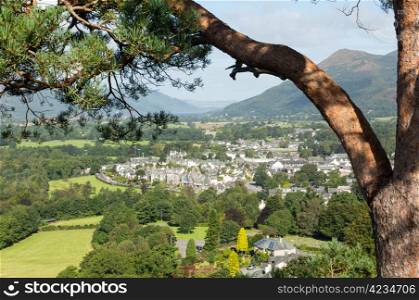 Framed by pine branch view over town of keswick in English Lake District