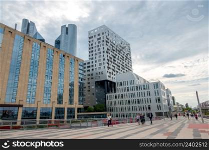 France. Cloudy summer day in the Parisian district of La Defense. Modern buildings and pedestrian street. Modern Office Buildings in the Parisian District of La Defense