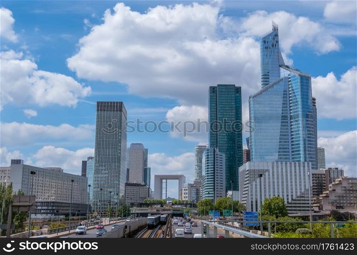 France. Paris. Modern district La Defense. Car traffic, skyscrapers and clouds. La Defense District of Modern Paris