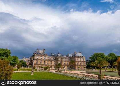 France. Paris. Summer in the Luxembourg Garden. Sunny day. Heavy rain clouds over the palace. Heavy Rain Clouds over the Luxembourg Palace in Paris