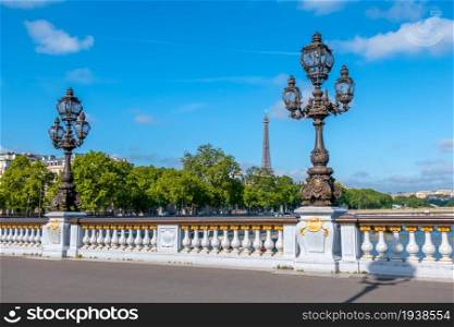 France, Paris. Summer sunny day. Lanterns on the bridge Alexandre III across the river Seine. Eiffel Tower in the distance. Lanterns on the Alexandre III Paris Bridge