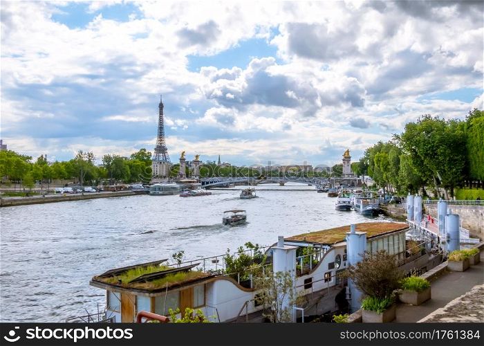 France. Paris. Sunny summer day. Water traffic on the River Seine with a view of the Eiffel Tower. Water Traffic on the River Seine