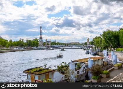 France. Paris. Sunny summer day. Water traffic on the River Seine with a view of the Eiffel Tower. Water Traffic on the River Seine