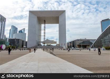 France. Summer day in the Parisian district of Defense. Grande Arche and the pedestrian square. Grande Arche and the Pedestrian Square in Defense District