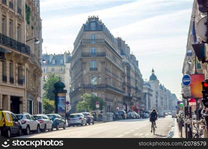 France. Sunny summer day in Paris. One of the main streets. Lots of parked cars. Sunny Summer Street of Paris and a Lot of Parked Cars