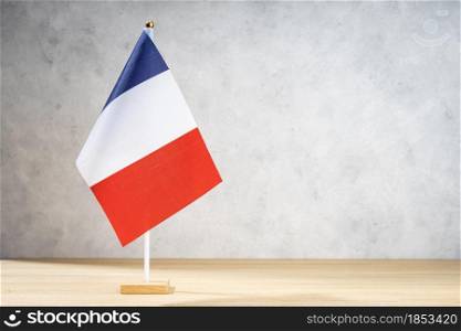France table flag on white textured wall. Copy space for text, designs or drawings