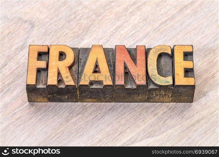 France word in vintage letterpress wood type against grained wood