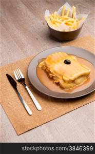 Francesinha and french fries, typical food from Porto, Portugal