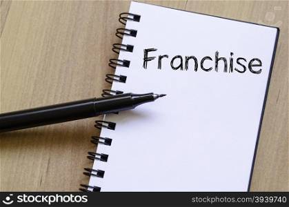 Franchise text concept write on notebook with pen
