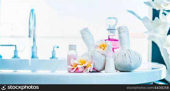 Frangipani flowers with herbal compress stamps , pink lotion bottle on luxury bath. Spa or wellness background
