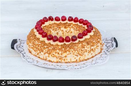 Frankfurt crown cake with cherries on white wooden. Frankfurt crown cake with cherries on white wooden.