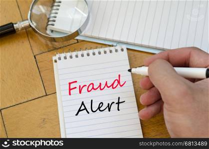 Fraud alert text concept write on notebook