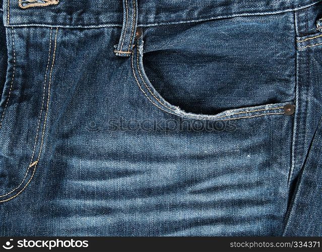 frayed empty front pocket of blue jeans, full frame