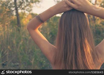 Free and alone. Blonde against sunset in summer colorized image